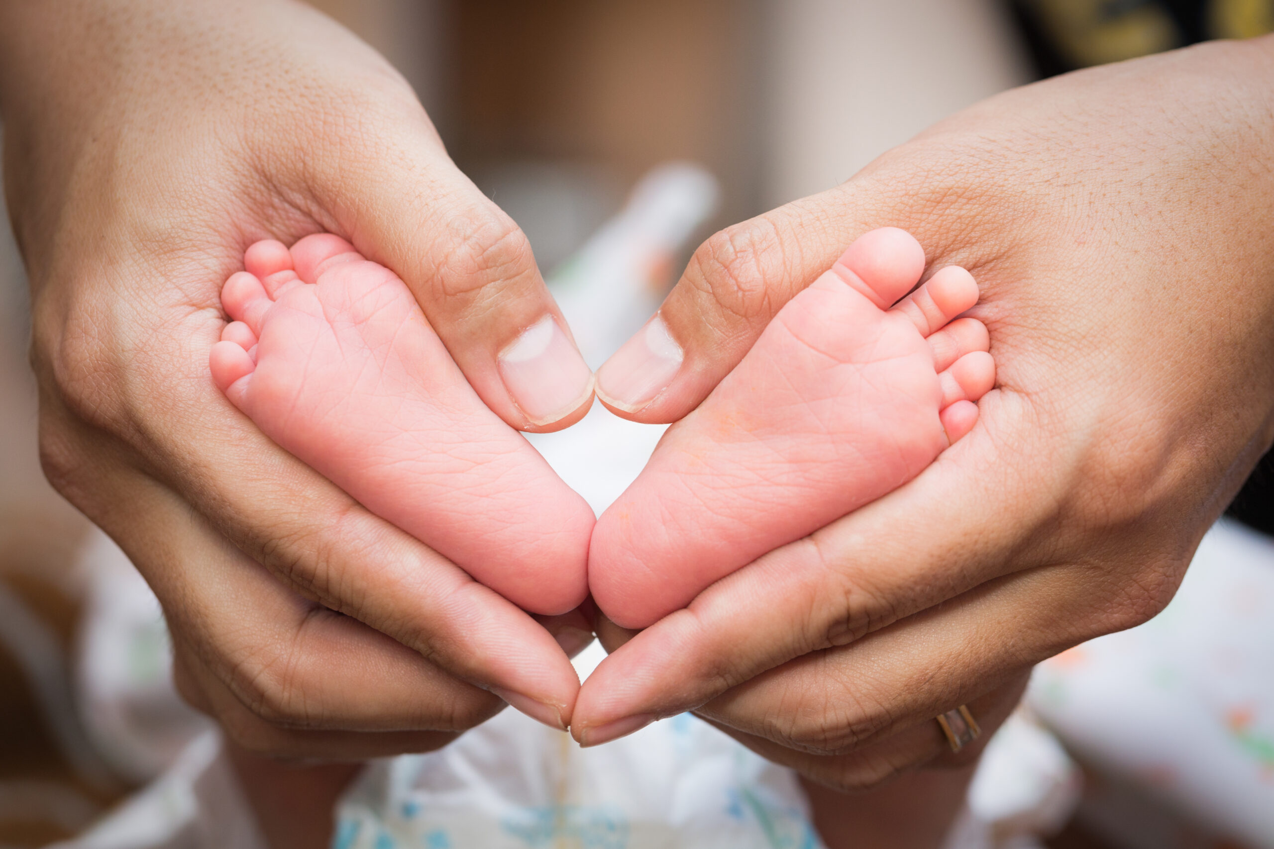 vecteezy baby feet in the father hands 27302348 scaled