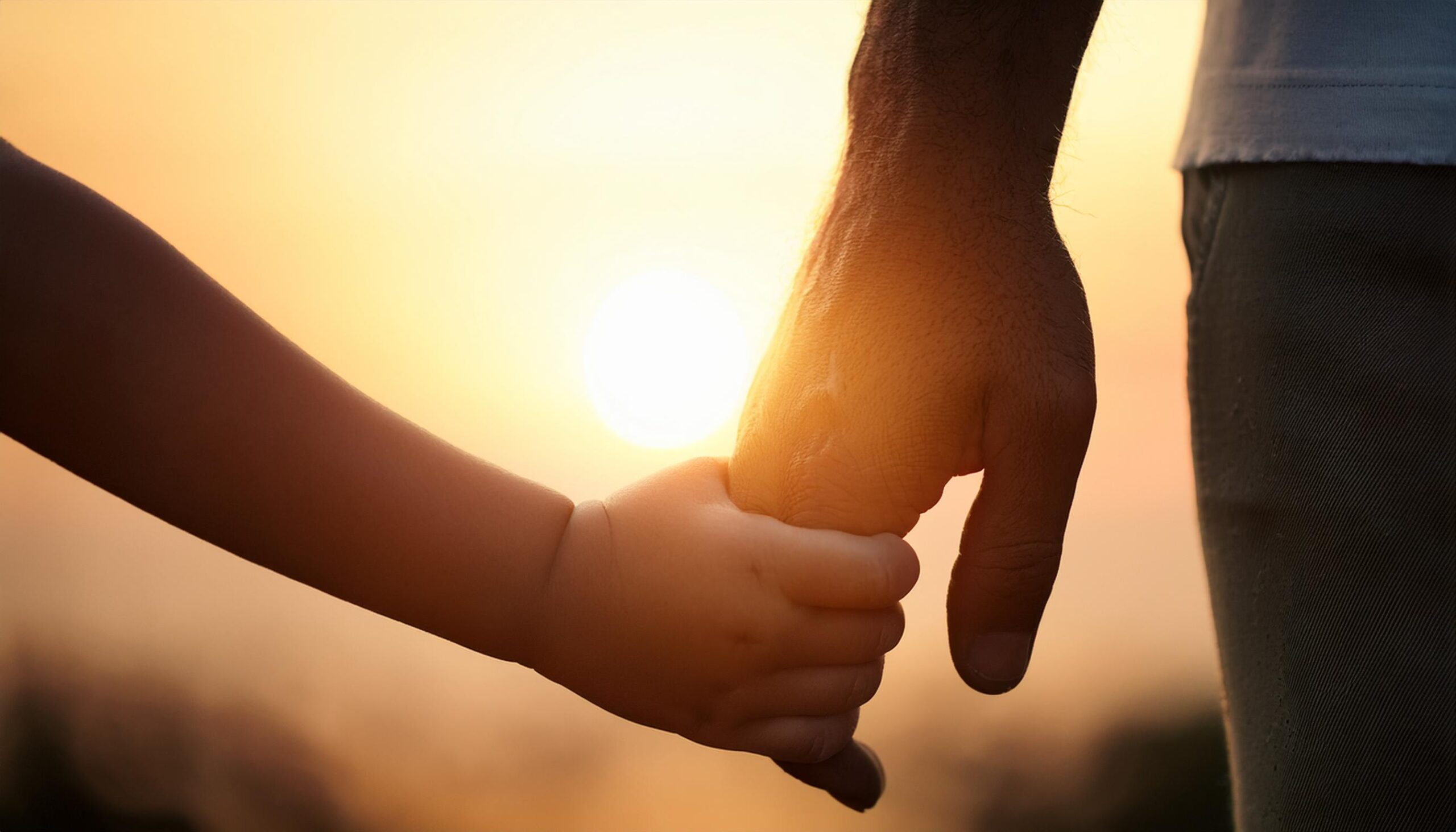 vecteezy close up of a child and adult holding hands against a warm 51184495 scaled