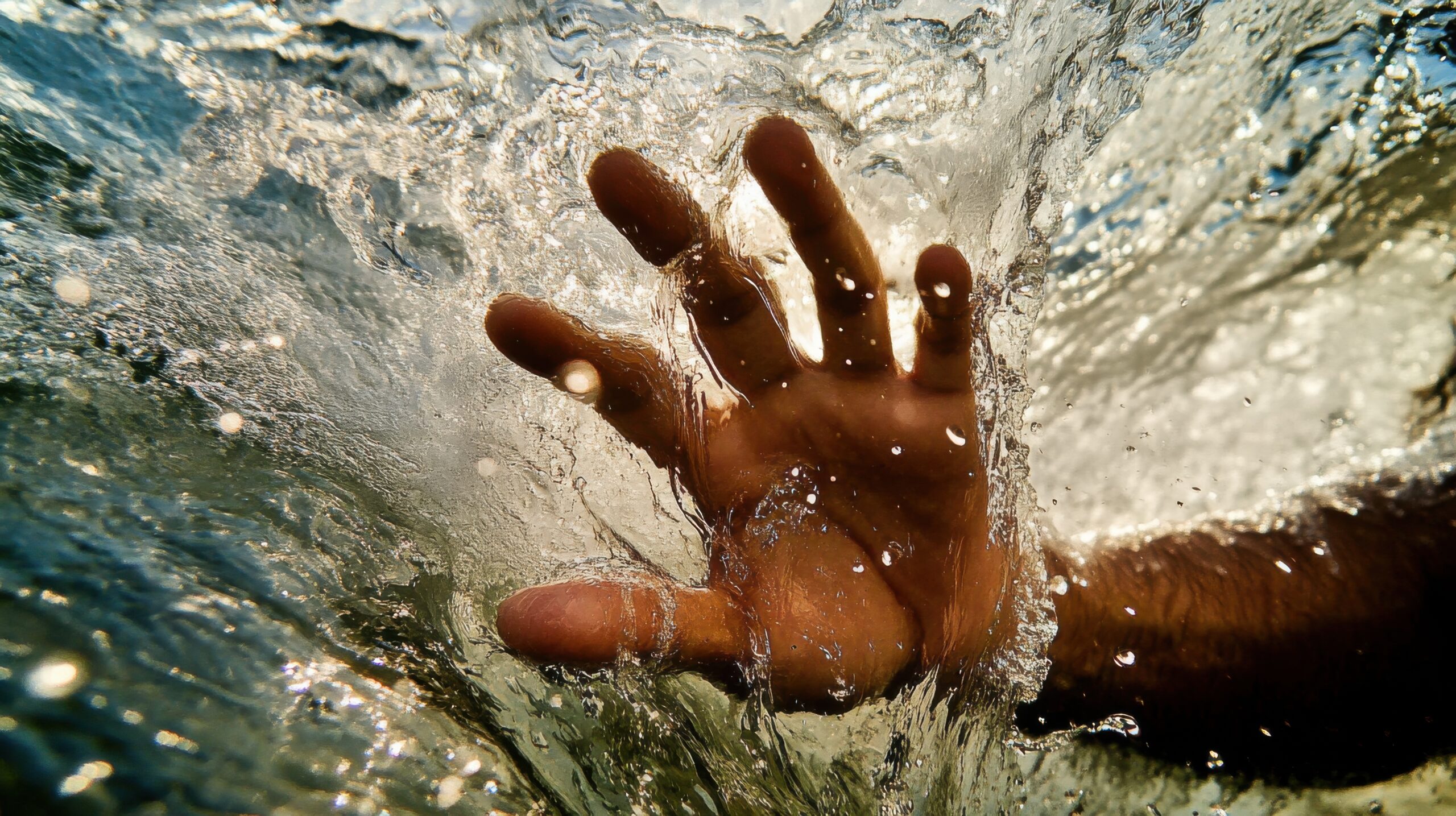 vecteezy a person s hand is in the water and is being splashed 71014307 scaled