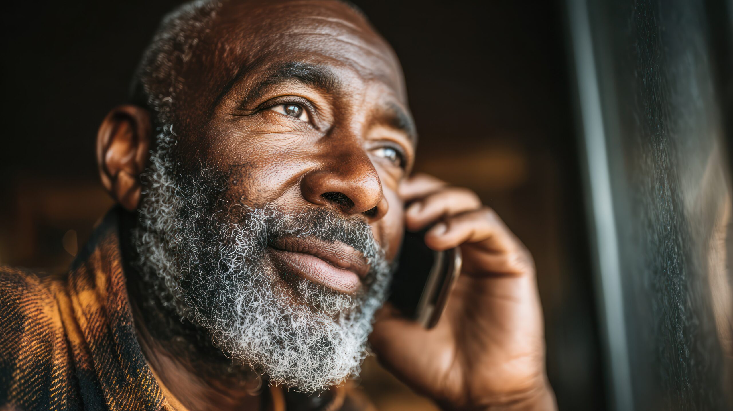 vecteezy african american senior man using a mobile phone by the window 76918509 scaled