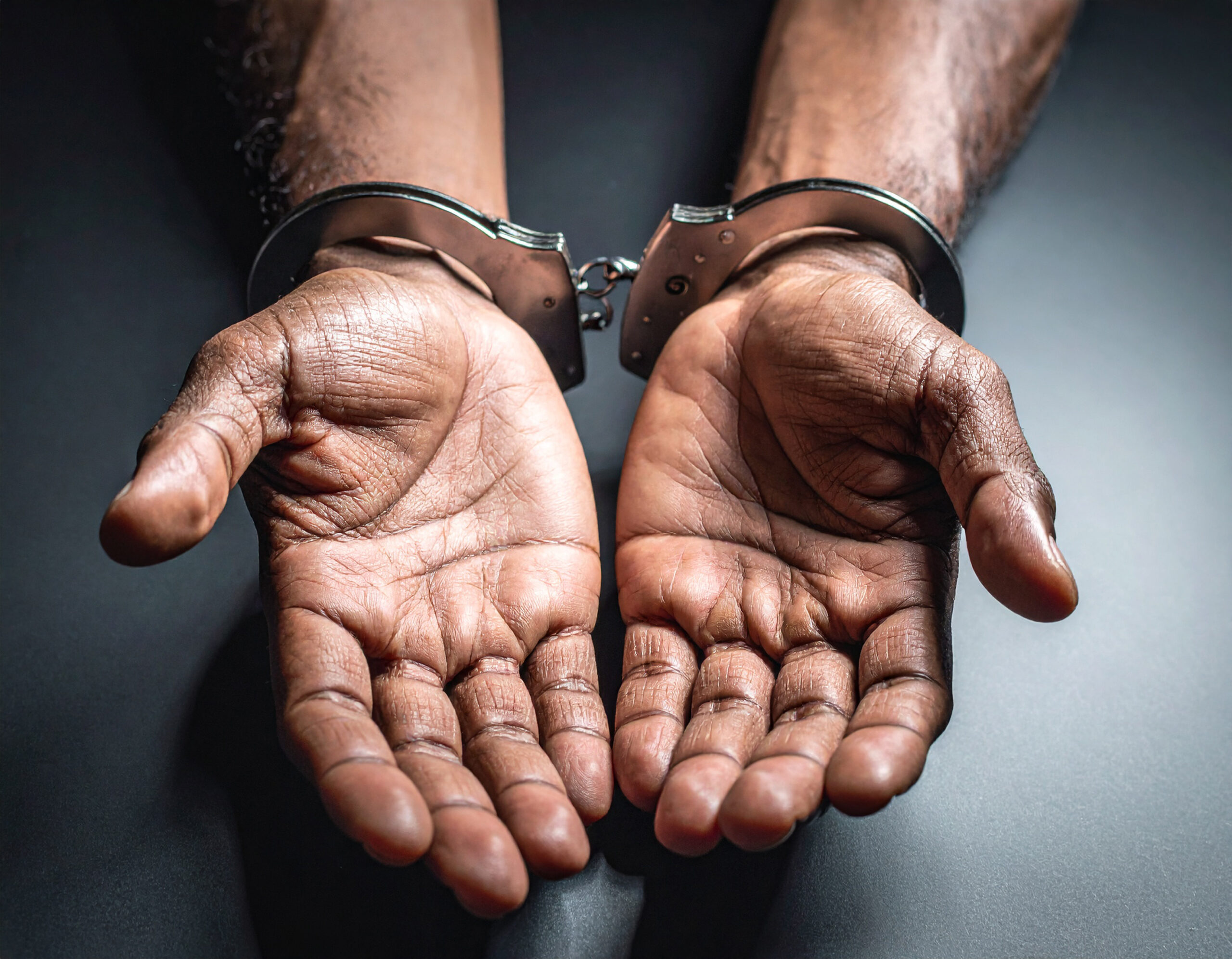 vecteezy close up of hands in handcuffs 74269454 1 scaled