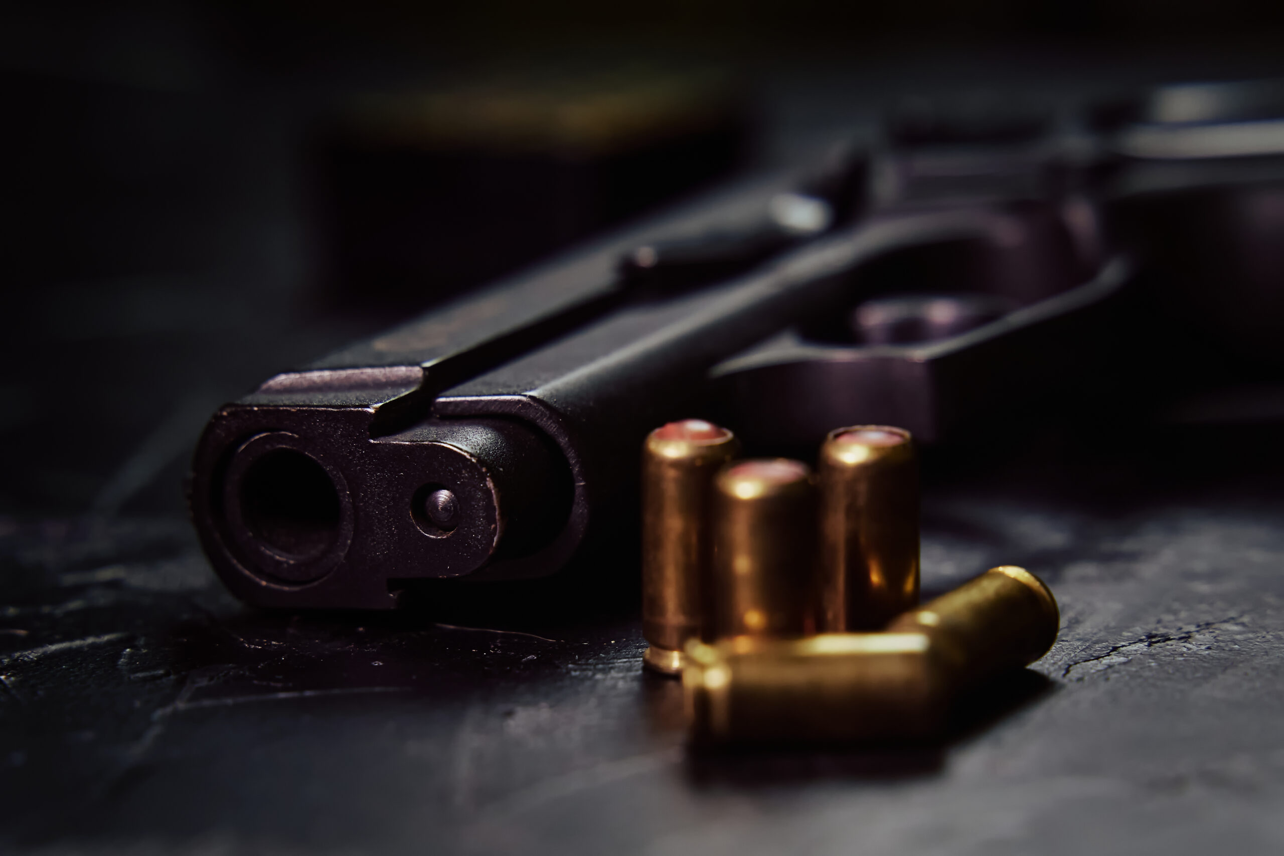 vecteezy pistol with cartridges on black concrete table 14260478 scaled